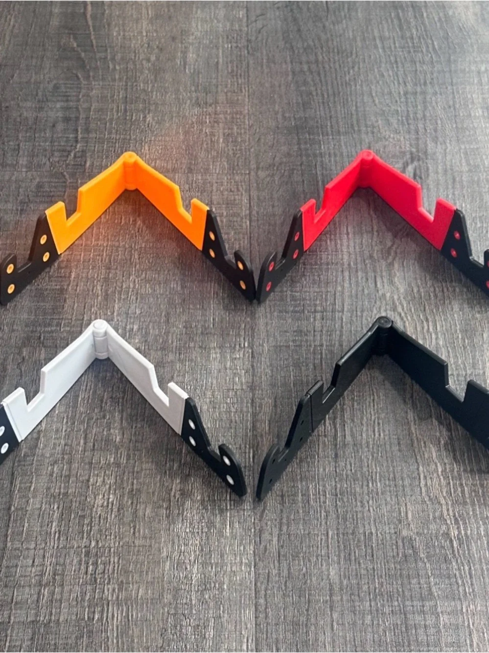 New Pack of 4 Universal Folding Phone Stands in Black, White, Red & Orange